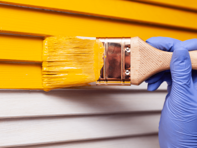closeup-female-hand-purple-rubber-glove-with-paintbrush-painting-natural-wooden-door-with-orange-paint-colored-bright-creative-design-interior-how-pa closeup-female-hand-purple-rubber-glove-with-paintbrush-painting-natural-wooden-door-with-orange-paint-colored-bright-creative-design-interior-how-pa
